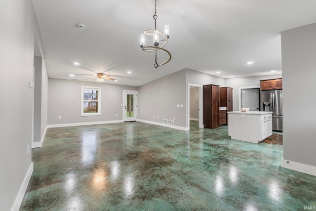 unfurnished living room with ceiling fan with notable chandelier