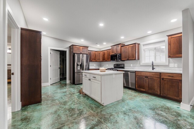 kitchen featuring sink, a kitchen island, and black appliances