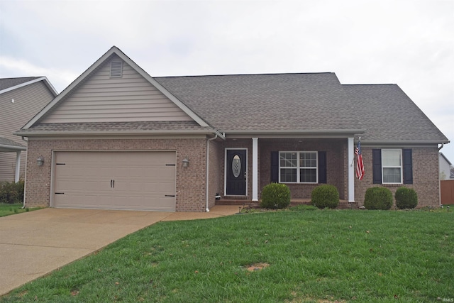 ranch-style home featuring a garage and a front lawn