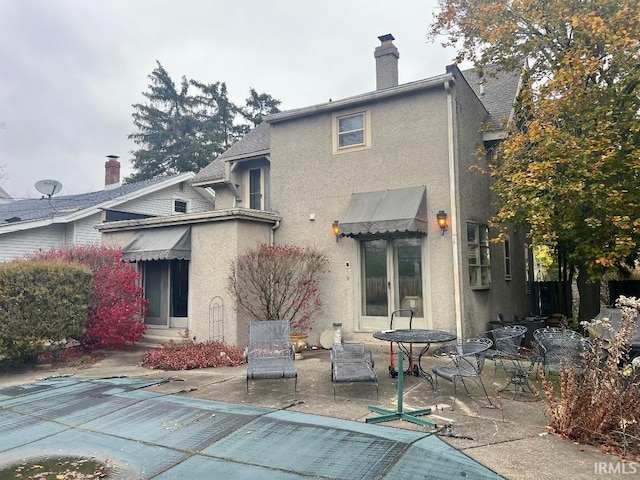 back of house with a patio