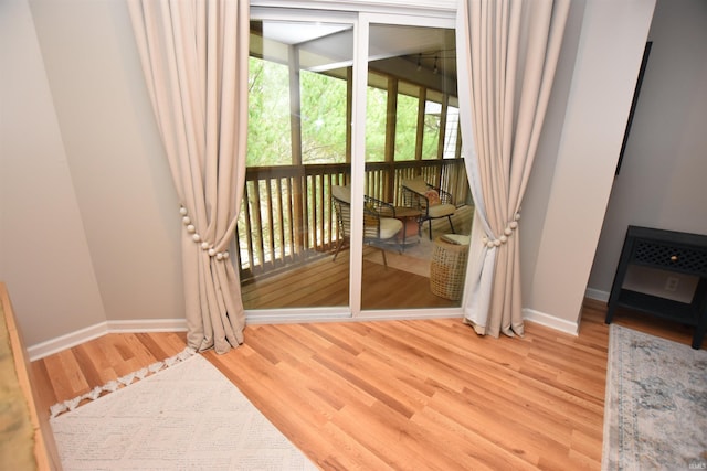 doorway to outside with wood-type flooring