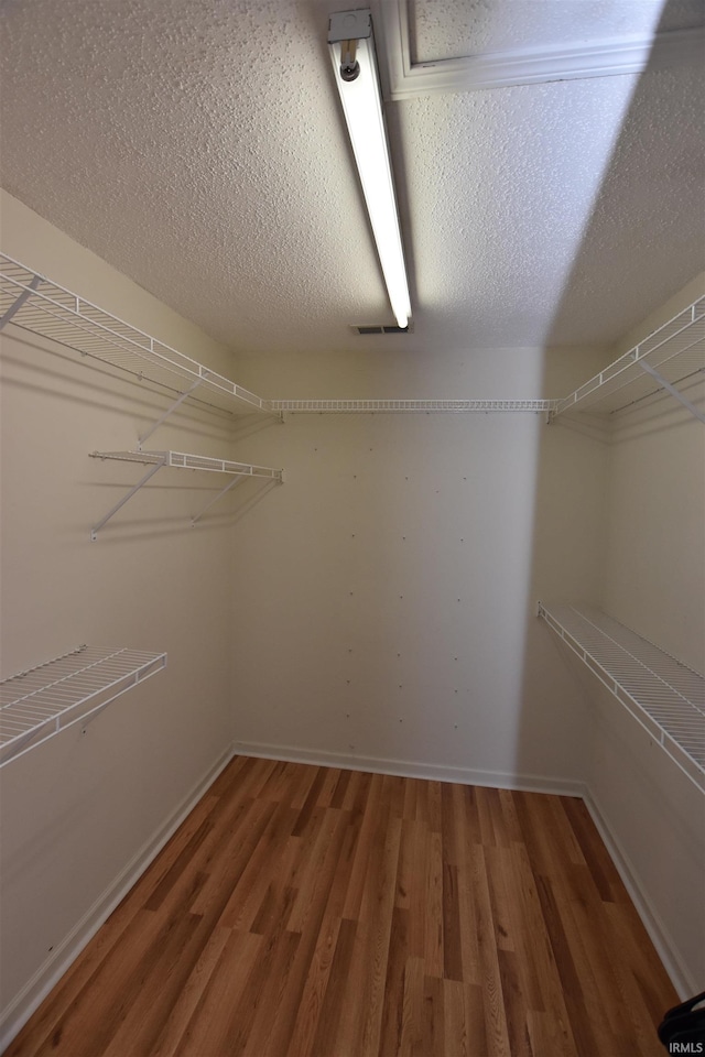 walk in closet featuring hardwood / wood-style floors