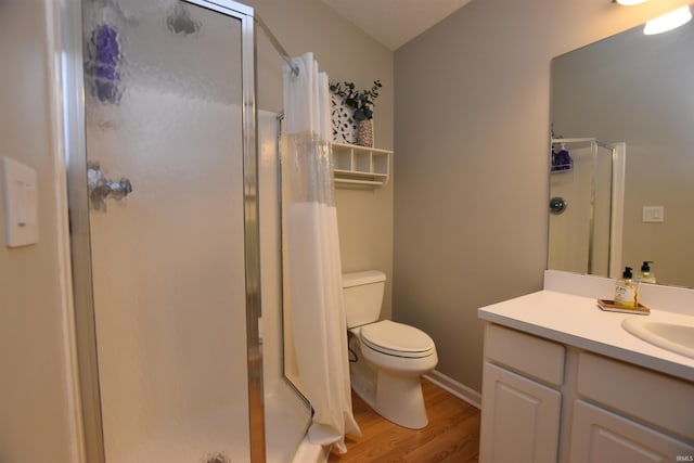 bathroom featuring a shower with curtain, vanity, hardwood / wood-style flooring, and toilet