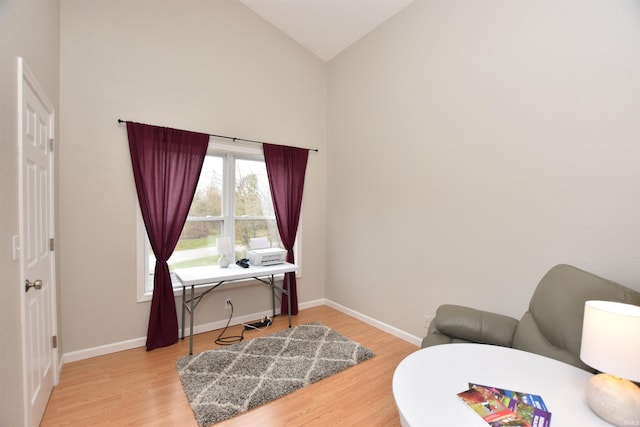 interior space with hardwood / wood-style flooring and high vaulted ceiling