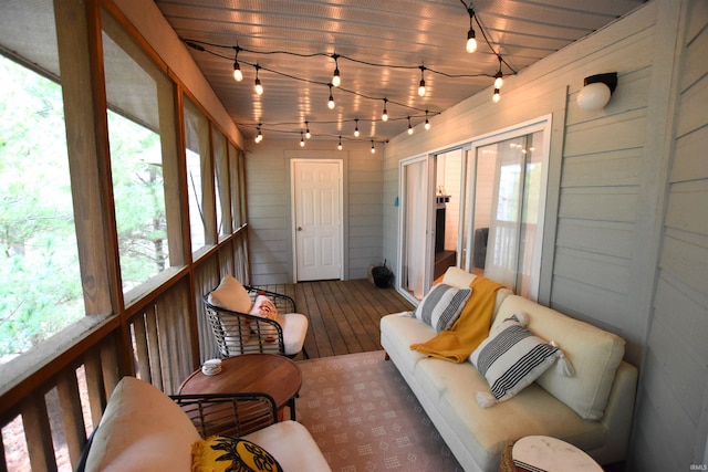 sunroom / solarium featuring rail lighting