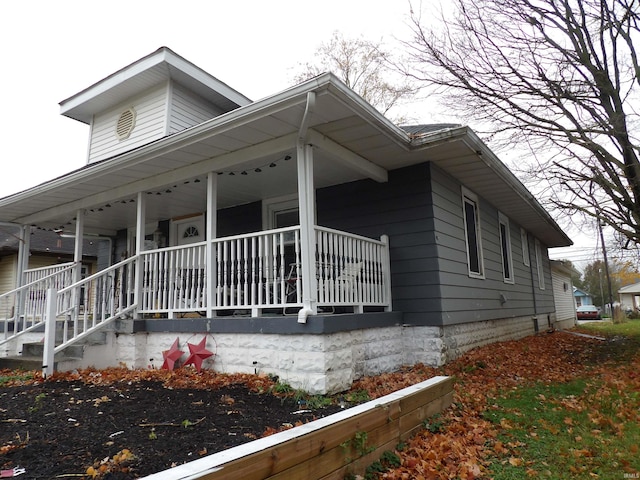 view of property exterior featuring covered porch