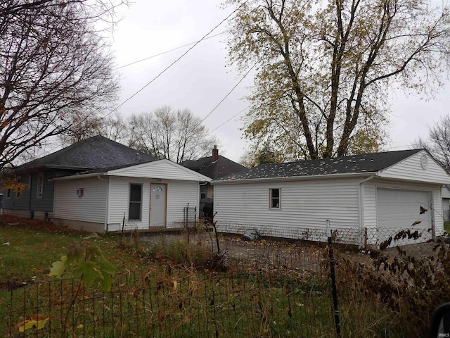 back of house with a garage