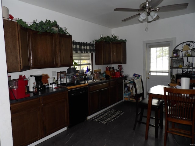 kitchen with dark brown cabinetry, black dishwasher, ceiling fan, and sink