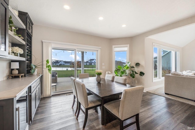 dining room with dark hardwood / wood-style floors and wine cooler