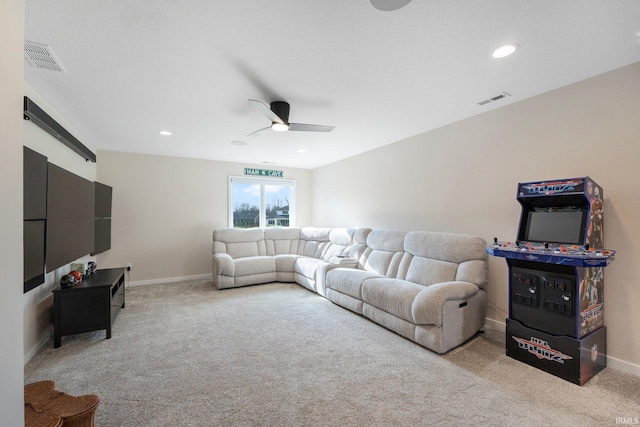 carpeted living room with ceiling fan