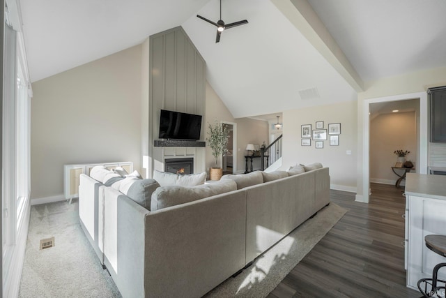 living room with hardwood / wood-style floors, high vaulted ceiling, and ceiling fan