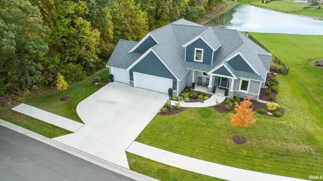 view of front of property featuring a water view, a garage, a porch, and a front yard