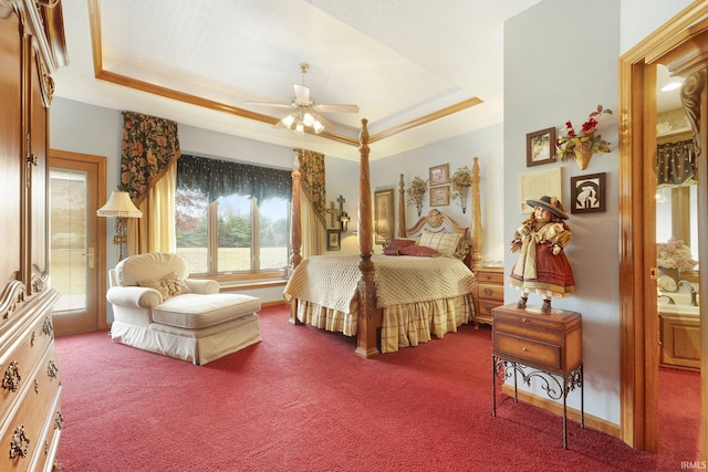 bedroom featuring carpet, a raised ceiling, and ceiling fan