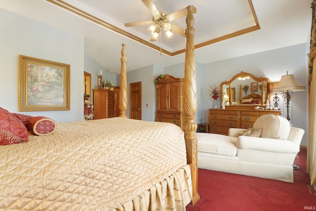 bedroom featuring carpet, a tray ceiling, and ceiling fan