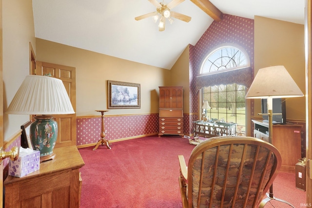 sitting room with carpet flooring, vaulted ceiling with beams, and ceiling fan