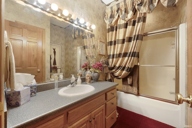 bathroom featuring vanity and enclosed tub / shower combo