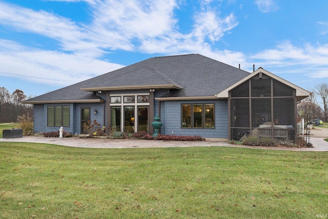 back of property featuring a sunroom and a yard