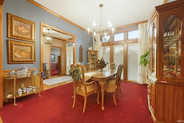 dining space featuring an inviting chandelier, dark carpet, and crown molding