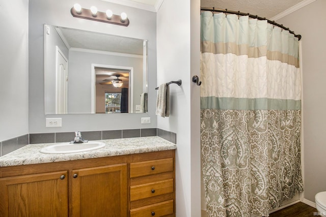 bathroom featuring vanity, toilet, ceiling fan, and crown molding