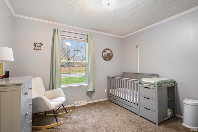 carpeted bedroom featuring ornamental molding, a textured ceiling, and a nursery area