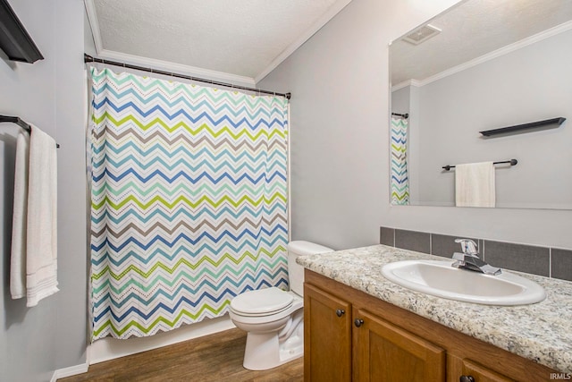 bathroom with crown molding, a textured ceiling, toilet, vanity, and hardwood / wood-style flooring