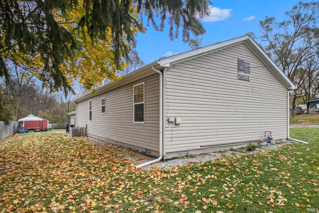 view of home's exterior featuring a yard and a shed