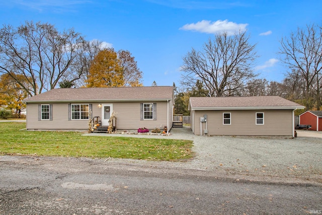 view of front facade featuring an outbuilding and a front yard