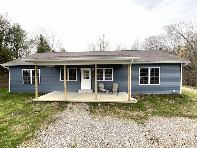 rear view of house with a yard and a patio area