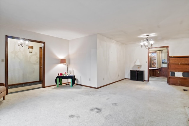 unfurnished living room with a notable chandelier and light carpet