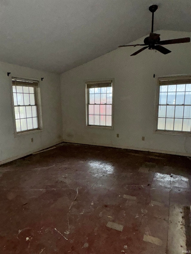 unfurnished room with ceiling fan, a healthy amount of sunlight, and vaulted ceiling