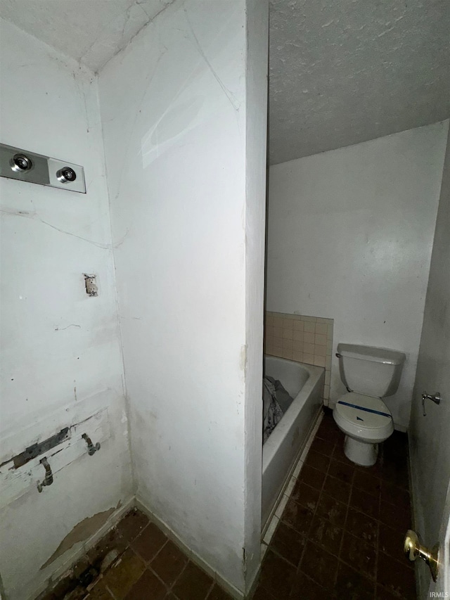 bathroom with toilet and a tub