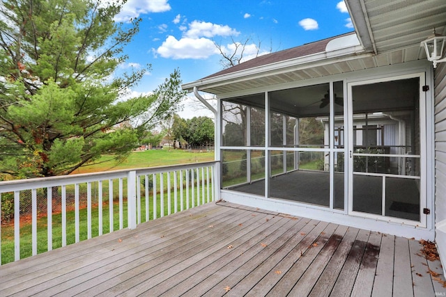 wooden terrace with a sunroom and a yard