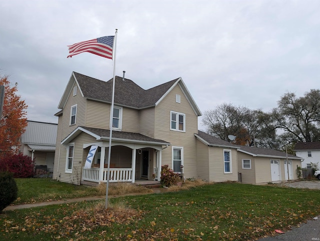 view of front facade featuring a front lawn, a porch, and a garage