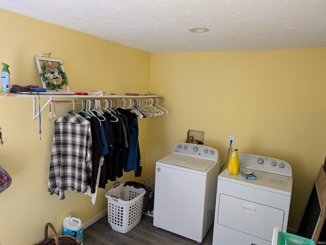 laundry room with dark hardwood / wood-style floors, washing machine and dryer, and a textured ceiling