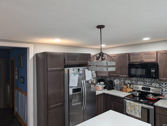 kitchen with tasteful backsplash, dark brown cabinetry, hanging light fixtures, and stainless steel appliances