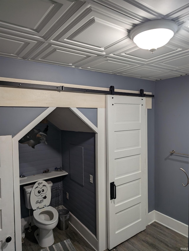 bathroom with hardwood / wood-style floors and toilet