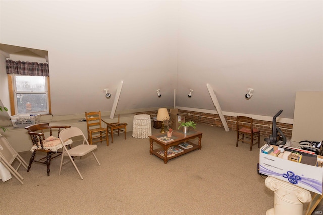 living area featuring carpet flooring and vaulted ceiling