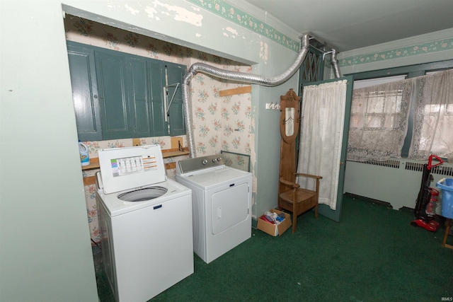 laundry area featuring washing machine and dryer, radiator heating unit, and dark carpet