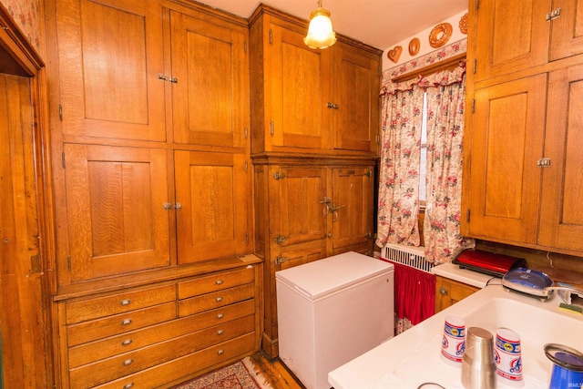 laundry room with hardwood / wood-style flooring