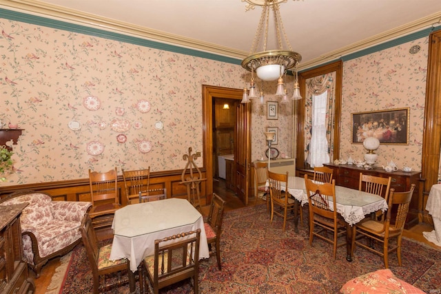 dining area with crown molding and an inviting chandelier