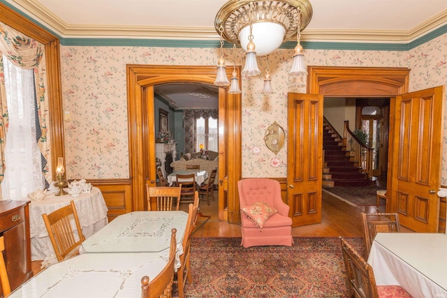 dining space featuring dark hardwood / wood-style flooring and ornamental molding