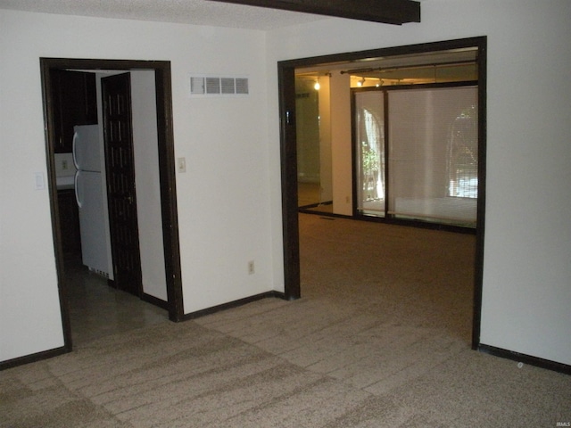 carpeted empty room featuring a textured ceiling