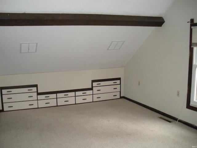 additional living space with light carpet and vaulted ceiling with beams