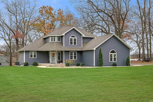 view of front of property with a front lawn and central air condition unit