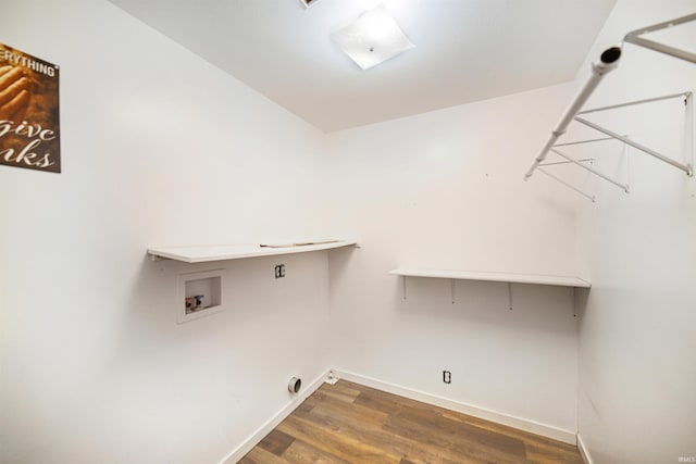 clothes washing area with dark wood-type flooring and washer hookup