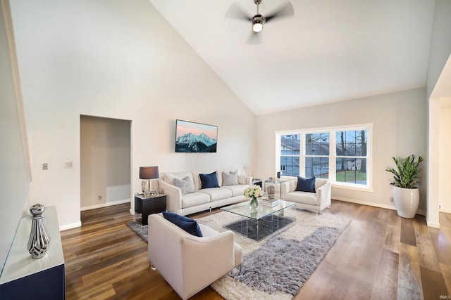 living room featuring ceiling fan, dark hardwood / wood-style flooring, and high vaulted ceiling