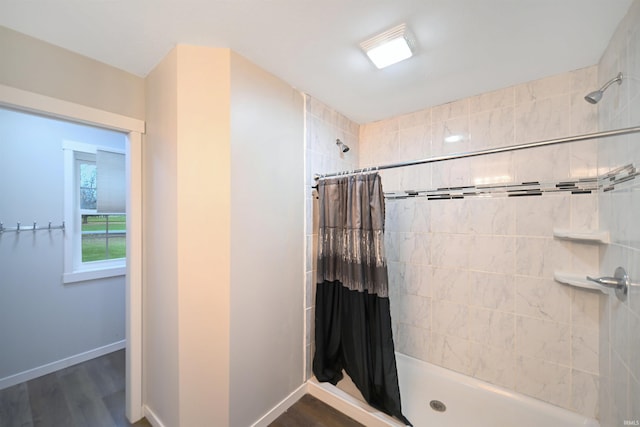 bathroom featuring hardwood / wood-style floors and a shower with shower curtain