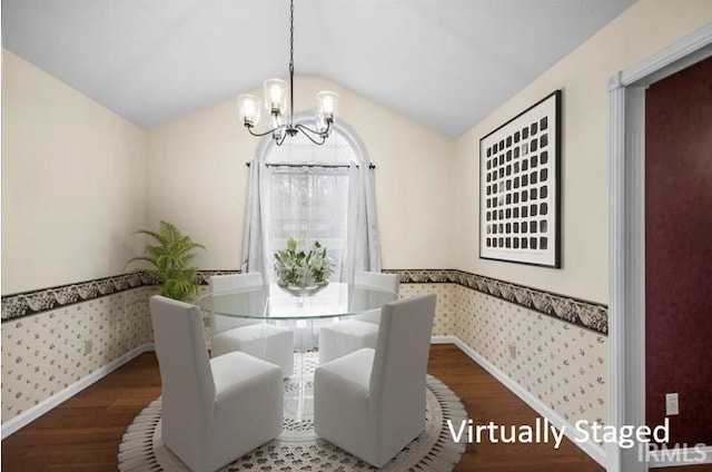 dining space with wood-type flooring, vaulted ceiling, and a notable chandelier