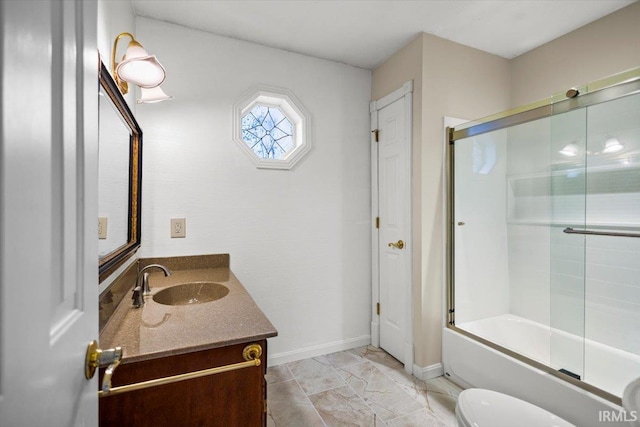 full bathroom with vanity, toilet, and bath / shower combo with glass door