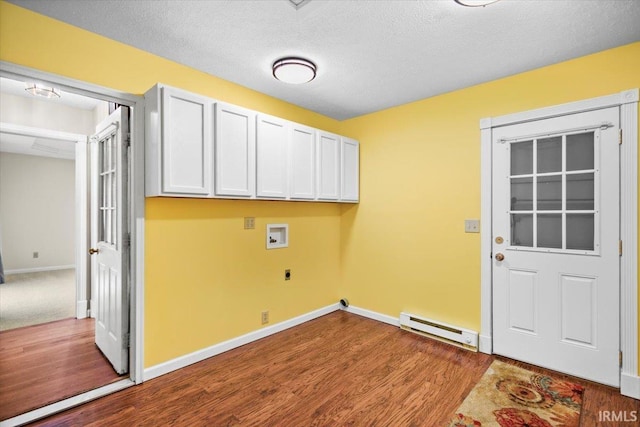 clothes washing area featuring hardwood / wood-style floors, electric dryer hookup, cabinets, washer hookup, and a baseboard radiator